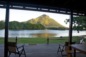 a view of a mountain from a porch at The River House in Tamarin