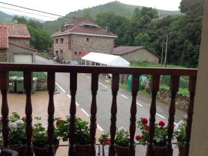 a view of a street from a balcony with flowers at Posada Rural Peñasagra in Quintanilla