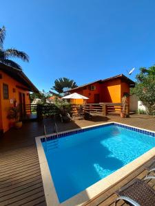 a swimming pool in front of a house at Pousada Parque da Mata in Paraty