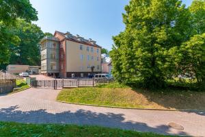 a large building with a tree in front of it at Lossi Old Town Apartment in Tartu