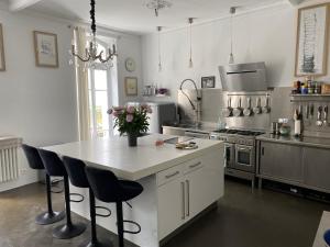 a kitchen with a white island with a counter top at La maison d’arles in Arles