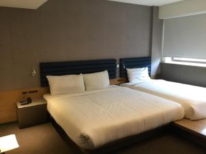 Voodi või voodid majutusasutuse Fu Kuang Hotel toas