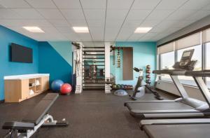 a gym with blue walls and exercising equipment in a room at AVID Hotels Corpus Christi - Portland, an IHG Hotel in Portland