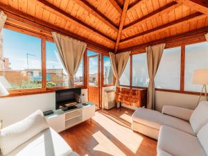 a living room filled with furniture and windows at Villa al Duomo in Taormina