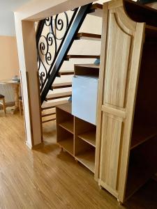 a room with a staircase with a wooden door at Casa Irlandeza - Irish House in Baile Felix