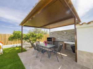 a patio with a table and chairs under a pavilion at Cubo's Villa Pilar in Alhaurín el Grande