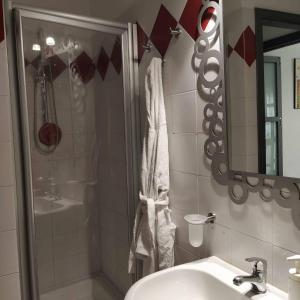 a bathroom with a shower and a sink and a mirror at Castagna Apartment Letojanni - Taormina in Letojanni