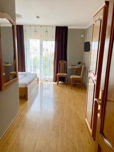 a bedroom with a bed and a table with chairs at Casa Irlandeza - Irish House in Baile Felix