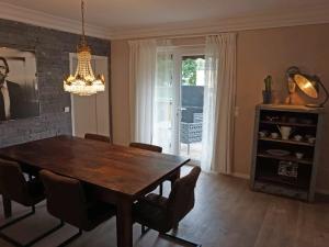 a dining room with a wooden table and chairs at Ferienwohnung Jill Schleiden in Schleiden +19 photos