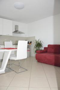 a living room with a red couch and a table at Apartment MARO in Senj