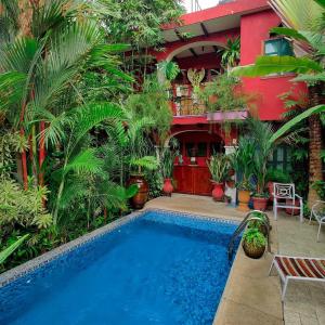 a swimming pool in front of a house with plants at Hotel Boutique Casona Maya Mexicana in Tapachula