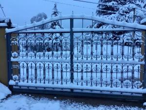 a gate covered in snow at Cielo de Piedra. Cabañas y Petit Hotel in Tanti