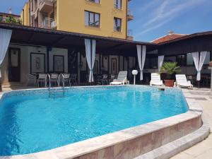 a swimming pool in front of a building at Slantse in Sozopol