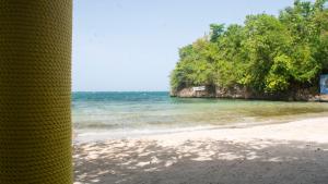 a view of a beach with trees and the ocean at Sunset Nabro in St Mary