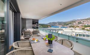 a balcony with a table and chairs and a view at Apartment Porto's Dubrovnik in Dubrovnik