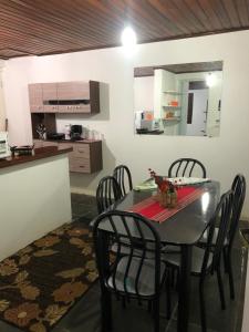 a kitchen and dining room with a table and chairs at Lar doce lar da Neuza in Campos do Jordão +6 photos