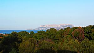 a view of the ocean and mountains in the distance at Sole Matto Rooms in Olbia