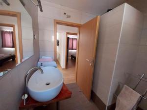 a bathroom with a white sink and a shower at Frane Apartment in Zavalatica