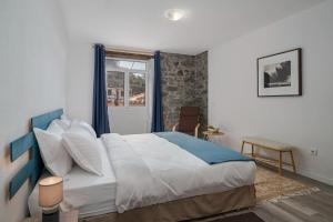 a bedroom with a large bed and a window at The Rum Inn in Calheta