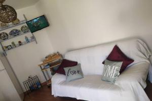 a white couch with pillows that say i love me at Villa Terra da Eira T1 - Sun, Sea and Relax in Lourinhã