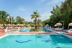 a swimming pool with dolphins in the water at Montespina Park Hotel in Naples