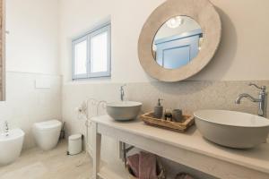 a bathroom with two sinks and a mirror at B&B Antico Telaio in Santa Maria Navarrese