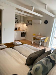 a large bed sitting in a room with a kitchen at Hartel House in Ollerup