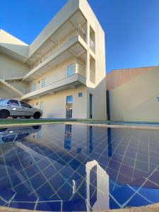 a building with a car parked in front of it at Pousada Life in Ubajara