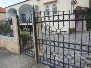 an iron gate in front of a house at Enjoy Inn in Nea Karvali