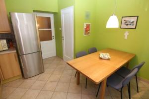 een keuken met een houten tafel en een koelkast bij Fast Friend - cozy apartment in the center with private garage in Rijeka