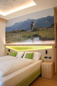 a hotel room with a bed and a tv at Agriturismo Maso Schneider in Cavalese
