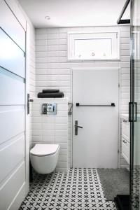 a bathroom with a toilet and a white door at Kawalerka na Starym Rynku in Toruń