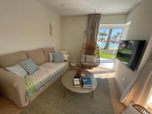 salon z kanapą i stołem w obiekcie Oasis Beach Apartment w Corralejo