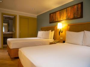 Postel nebo postele na pokoji v ubytování Grand Hotel Guayaquil, Ascend Hotel Collection
