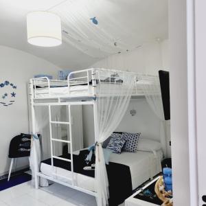 a bedroom with a bunk bed with a ladder at Blue Castle in Salerno