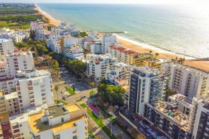 an aerial view of a city and the beach at Comfort Zone beach apartment in Quarteira