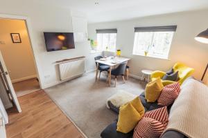 a living room with a couch and a table at The Hive Apartment in Marple
