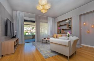 a living room with a couch and a tv at Apartment Porto's Dubrovnik in Dubrovnik