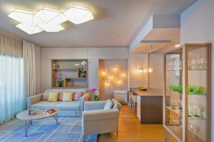 a living room with a blue couch and a table at Apartment Porto's Dubrovnik in Dubrovnik