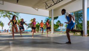 young people playing a game of frisbee at Riu Palace Tropical Bay - All Inclusive in Negril