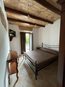 a bedroom with a bed and a wooden ceiling at La Vie En Rose in Fondi
