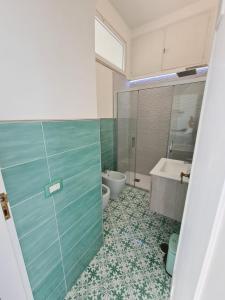 a bathroom with a shower and a toilet and a sink at Casa Leucosia Suites in Capri