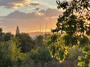 a sunset view of a building in the distance at Estudio a 400 metros Ribera FREE PARKING in Córdoba