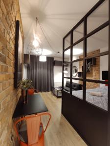 a room with a bed and a table and chairs at Red wall apartment in the Old Town in Gdańsk