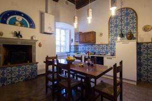 a kitchen with a table and chairs and a refrigerator at Appartamento del Capitano in Cortona