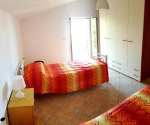 a bedroom with two beds and a window at PANORAMIC HOUSE -Santa Teresa di Riva- BANDIERA BLU in Santa Teresa di Riva