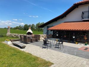 a patio with a table and chairs next to a building at AgroBorcz in Borcz