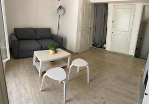 a living room with a couch and two chairs and a table at Location de la Carraire in Valensole