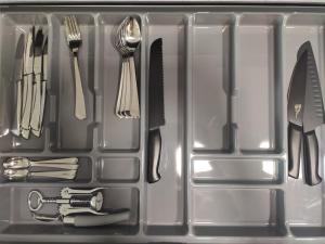 a plastic container with utensils in it at SEA GATE APARTMENT 20th floor in Klaipėda