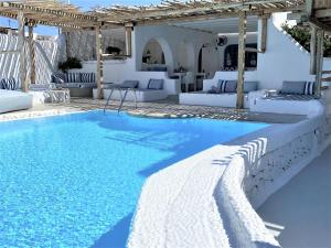 a swimming pool in the middle of a villa at Apsenti couples only in Agios Ioannis Mykonos